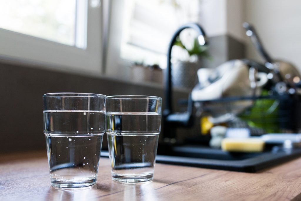 Two Glasses Of Water In Kitchen, With Tap Water And Two Bottles (Bigstock/Snowboy)
