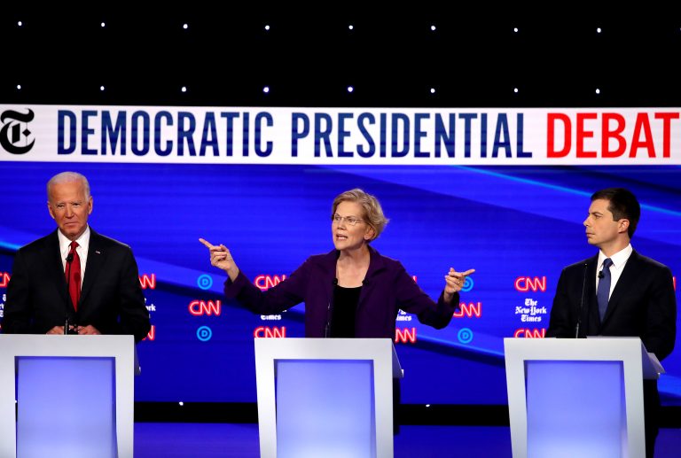 dm-gettyimages-1181321858_custom-a927290e036e543a41cd9aa5db7a5fe9c5f4f043-768×517 Left to right, former Vice President Joe Biden, Massuchusetts Sen. Elizabeth Warren and South Bend, Ind. Mayor Pete Buttigieg react on stage during the Democratic Presidential Debate at Otterbein University. (Getty Images)