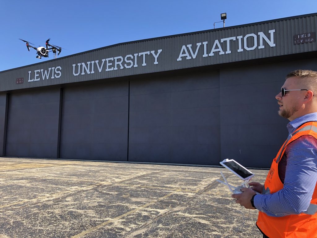 Jacob Reed, director of the Unmanned Aircraft Systems degree program at Lewis University, demonstrates a drone at the school’s airfield outside of Chicago. Jacob Reed, director of the Unmanned Aircraft Systems degree program at Lewis University, demonstrates a drone at the school's airfield outside of Chicago. (David Schaper/NPR)
