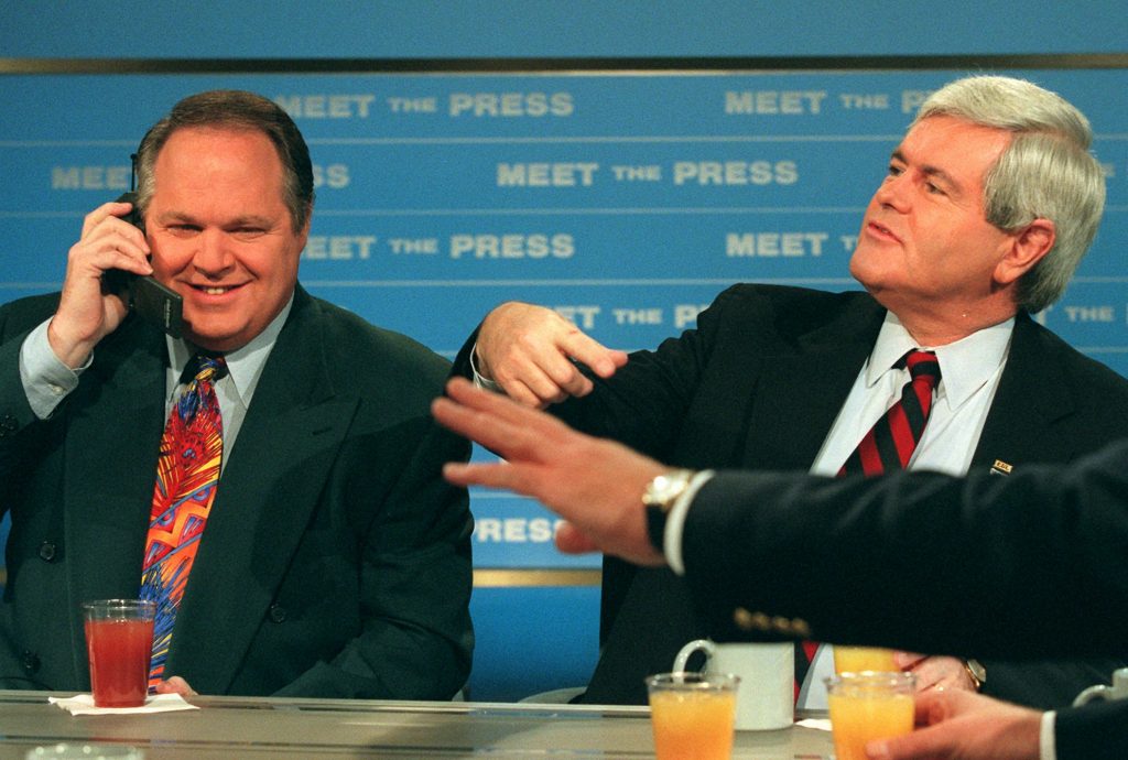 GINGRICH LIMBAUGH RUSSERT Radio talk show host Rush Limbaugh talks on a phone as House Speaker Newt Gingrich gestures during a break in taping of NBC's