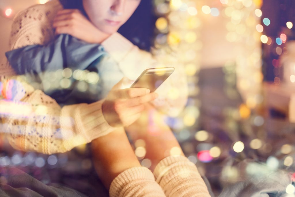 Girl texting on smartphone at home (martin-dm/Getty Images)