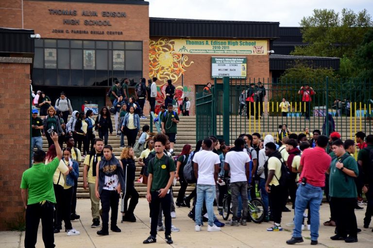 Students spill out of Thomas A. Edison High School at the end of the school day. Students who swipe their identification cards in the morning are considered present for the whole day — even when they cut class. (TOM GRALISH / Philadelphia Inquirer)