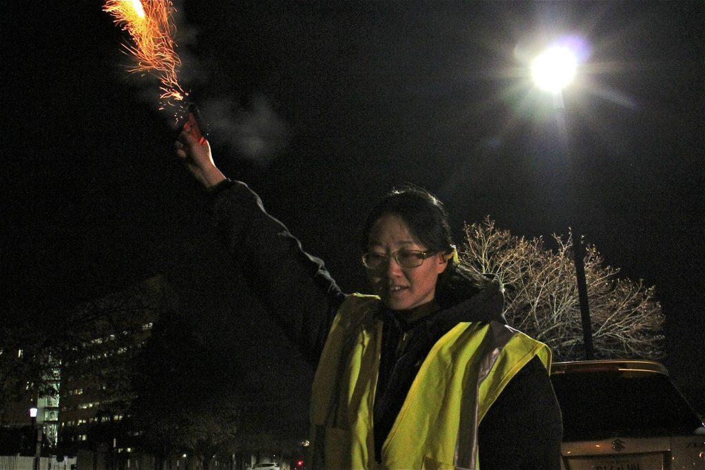 2019 11 19-e lee-april simnor-trenton nj-crow problem pyrotechnics USDA Wildlife Biologist April Simnor uses pyrotechnics to disperse crows in the parking lot behind New Jersey state government offices on West State Street in Trenton. (Emma Lee/WHYY)