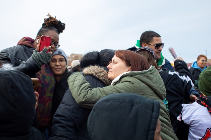 Christine Piper, Egg Harbor City resident and local chapter leader of Moms Demand Action, embraces another attendee at the march. Speakers encouraged unity and love among the community. (Becca Haydu for WHYY)