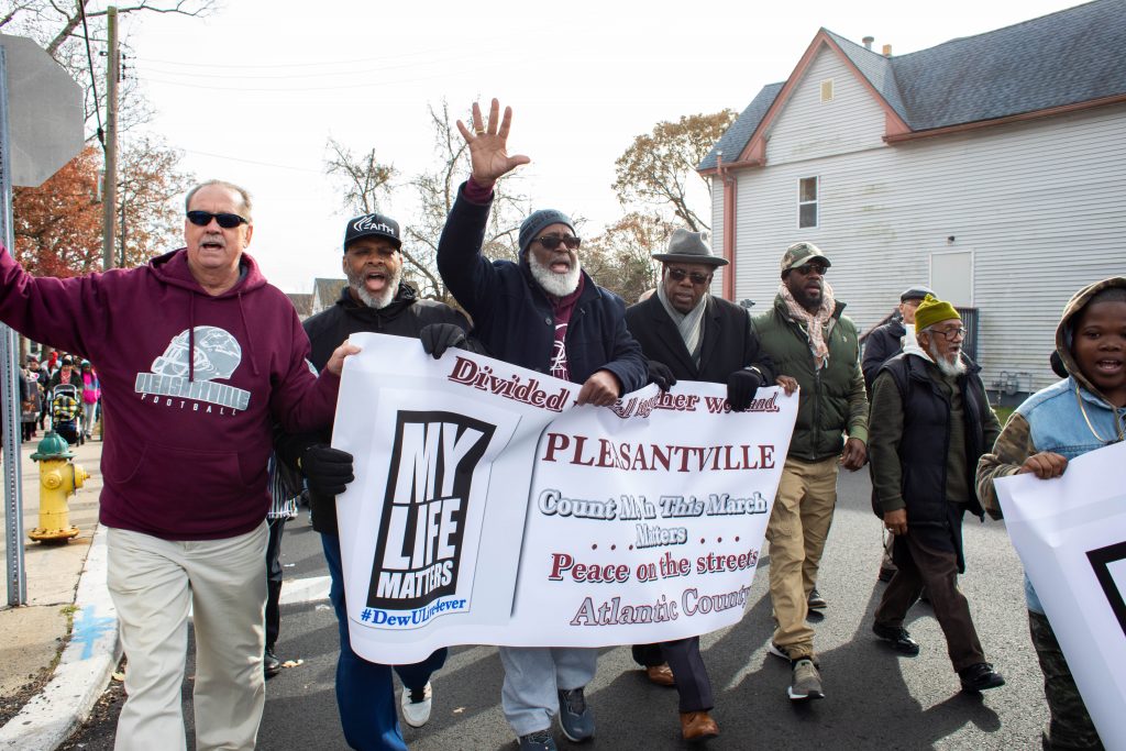 2019 11 23-b haydu-pleasantville new jersey-high school shooting gun violence march protest micah tennant-7 A group of male community leaders lead the march in recognition of the particular impact gun violence has on black men in the community. (Becca Haydu for WHYY)
