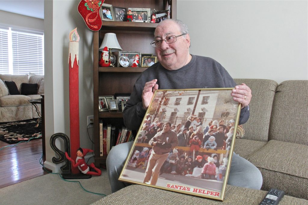 2019 11 26-e lee-robert dibenedetto-thanksgiving day parade memories Robert DiBenedetto holds a photo of himself working Philadelphia's Thanksgiving Day Parade in the early 1980s. (Emma Lee/WHYY)
