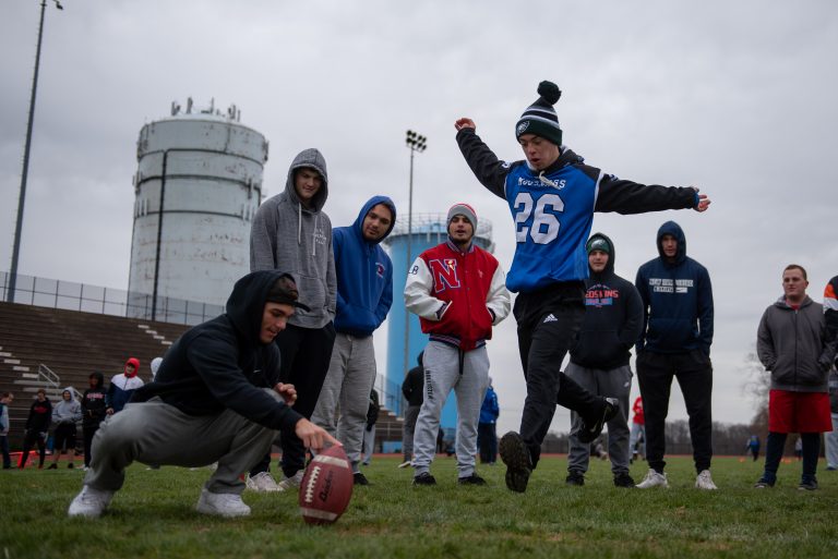 Justin Gabor runs up for a kick during practice at Neshaminy High School. (Kriston Jae Bethel for WHYY)