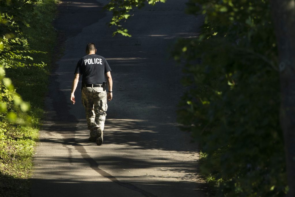 Missing Men An officer walks up a blocked off drive way, in, Solebury, Pa., as the search continues Wednesday, July 12, 2017, for four missing young Pennsylvania men feared to be the victims of foul play. (AP Photo/Matt Rourke)