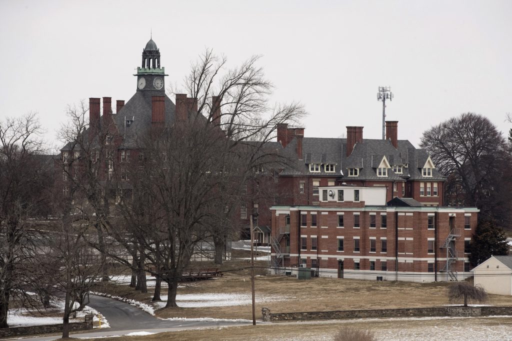 A view of a school building from afar on a cloudy day