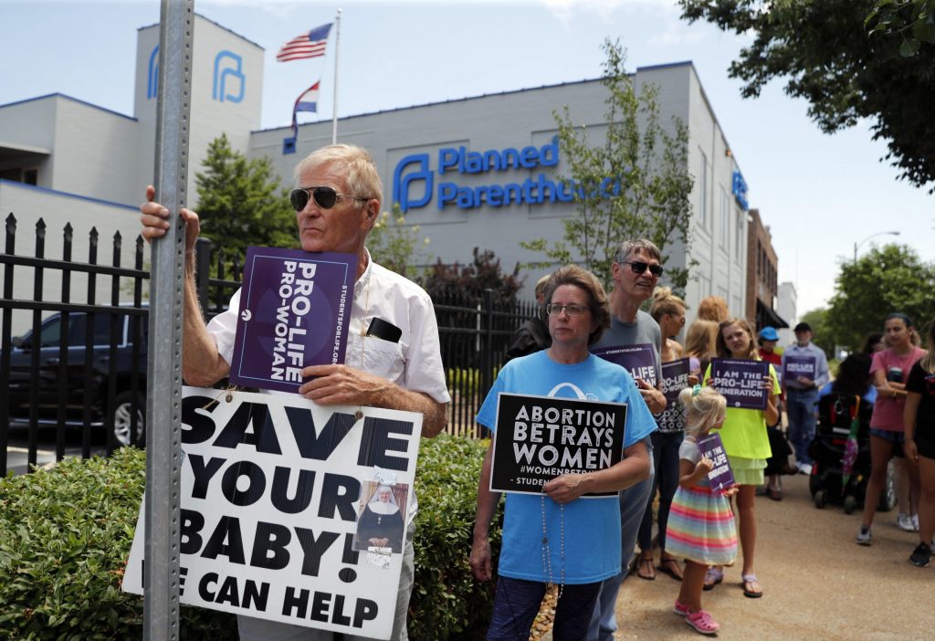 AP_19155652157297-1920×1316 In this June 4, 2019, file photo, Anti-abortion advocates gather outside the Planned Parenthood clinic in St. Louis. (Jeff Roberson / AP Photo)