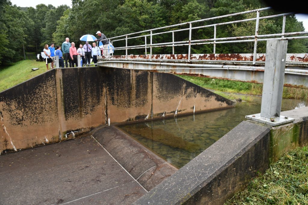 Dams-Legacy Of Neglect-Pennsylvania In this Sept. 28, 2019, file photo, officials look at damage to Heller Dam at Hagerman's Reservoir near South Williamsport, Pa. Pennsylvanians who live downstream from its many dams may not often think about what could happen, but inspectors know there are potential threats to life and property along the state's 86,000 miles of streams and rivers. (Mark Nance/Sun-Gazette via AP)