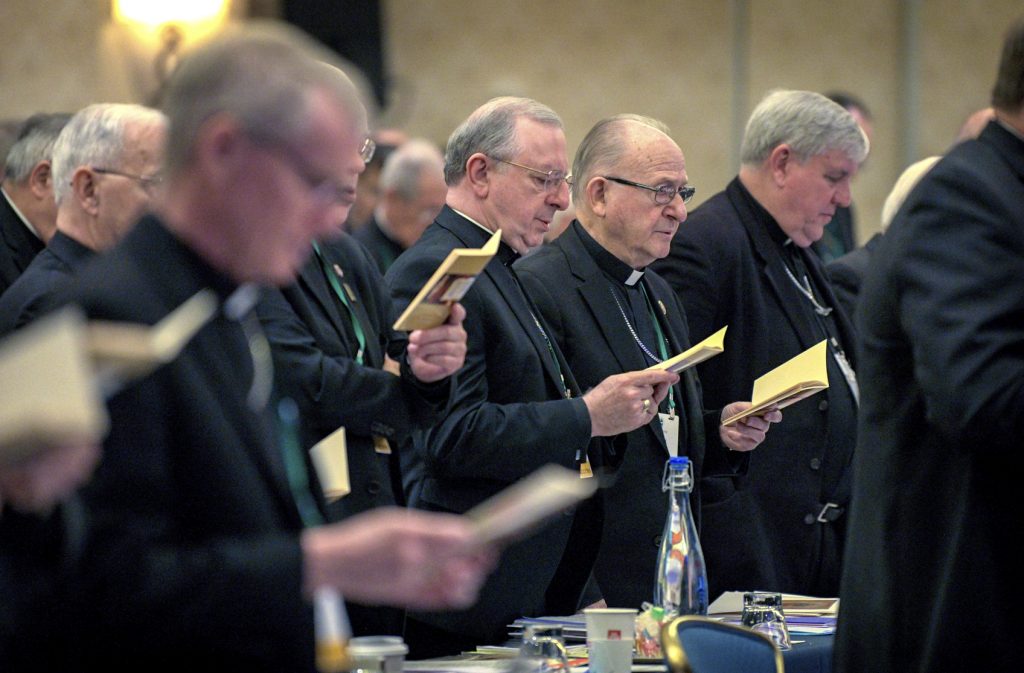 Catholic Bishops Bishops sing during an opening hymn at the start of the United States Conference of Catholic Bishops Fall General Assembly at the Baltimore Marriott Waterfront Monday, Nov. 11, 2019. (Jerry Jackson/The Baltimore Sun via AP)