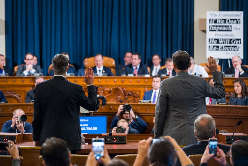 AP_19317562691379 Top U.S. diplomat in Ukraine William Taylor, left, and Career Foreign Service officer George Kent are sworn in prior to testifying before the House Intelligence Committee on Capitol Hill in Washington, Wednesday, Nov. 13, 2019, during the first public impeachment hearing of President Donald Trump's efforts to tie U.S. aid for Ukraine to investigations of his political opponents. (Jim Lo Scalzo/Pool Photo via AP)