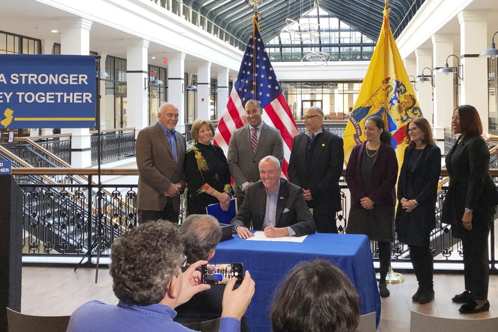 Public Bank New Jersey Democratic Gov. Phil Murphy signs an executive order creating a board to look into setting up a state-run bank, alongside labor and other supporters, Wednesday, Nov. 13, 2019 in Newark, N.J. New Jersey would be the second state after North Dakota with a state-run bank if Murphy's campaign promises comes to pass. (Michael Catalini/AP Photo)