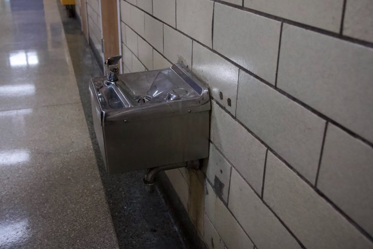a water fountain in a school hallway