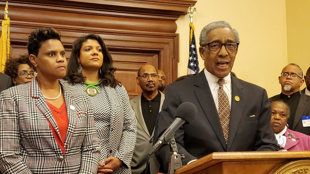 Members of the Legislative Black Caucus, Assemblywomen Shavonda Sumter, left and Britnee Timberlake; Sen. Ron Rice is at the podium. (NJ Spotlight) 