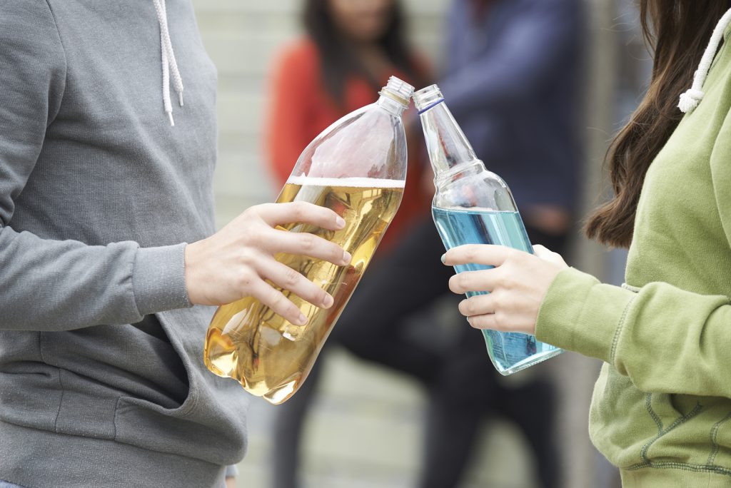 Close Up Of Teenage Group Drinking Alcohol Together Close Up Of Teenage Group Drinking Alcohol Together