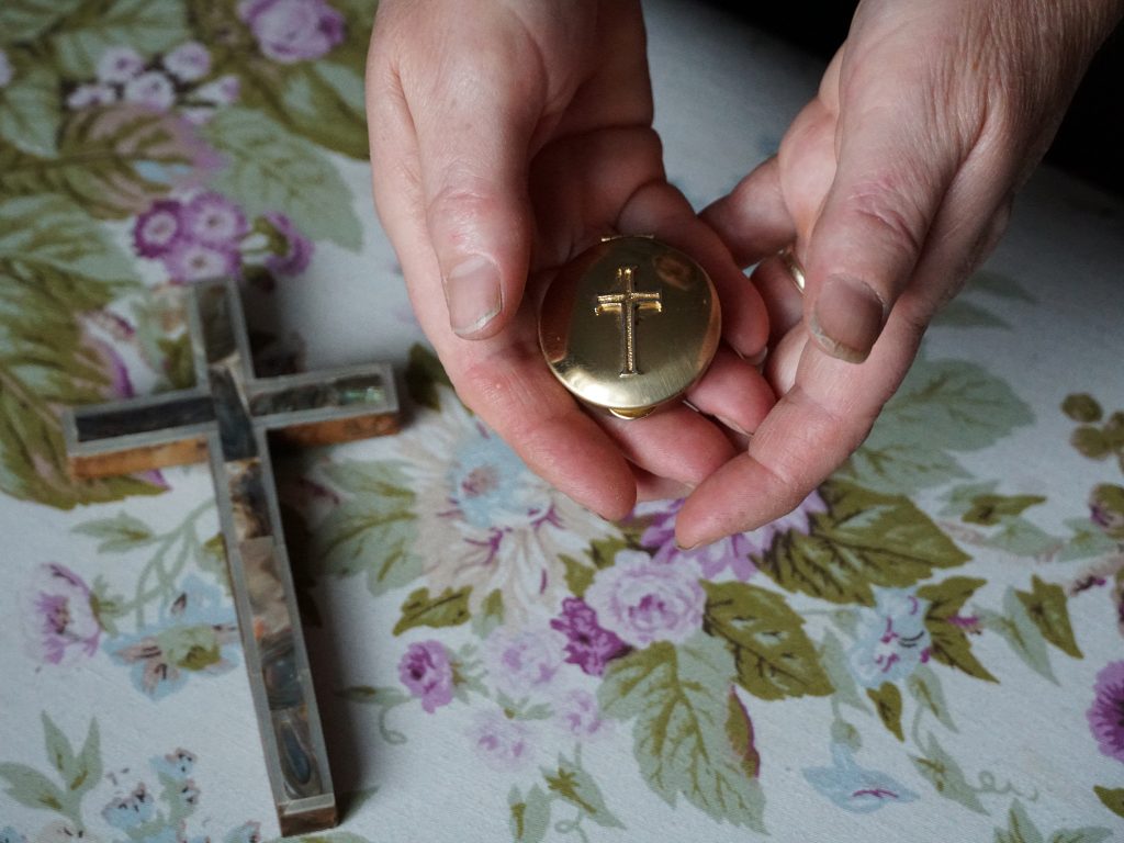 Marie Andrews holds a pyx, the vessel she uses to transport the consecrated Communion wafer to homebound parishioners. Andrews is an officially sanctioned Eucharistic minister in the Roman Catholic Church. Marie Andrews holds a pyx, the vessel she uses to transport the consecrated Communion wafer to homebound parishioners. Andrews is an officially sanctioned Eucharistic minister in the Roman Catholic Church. (Shahla Farzan/St. Louis Public Radio)