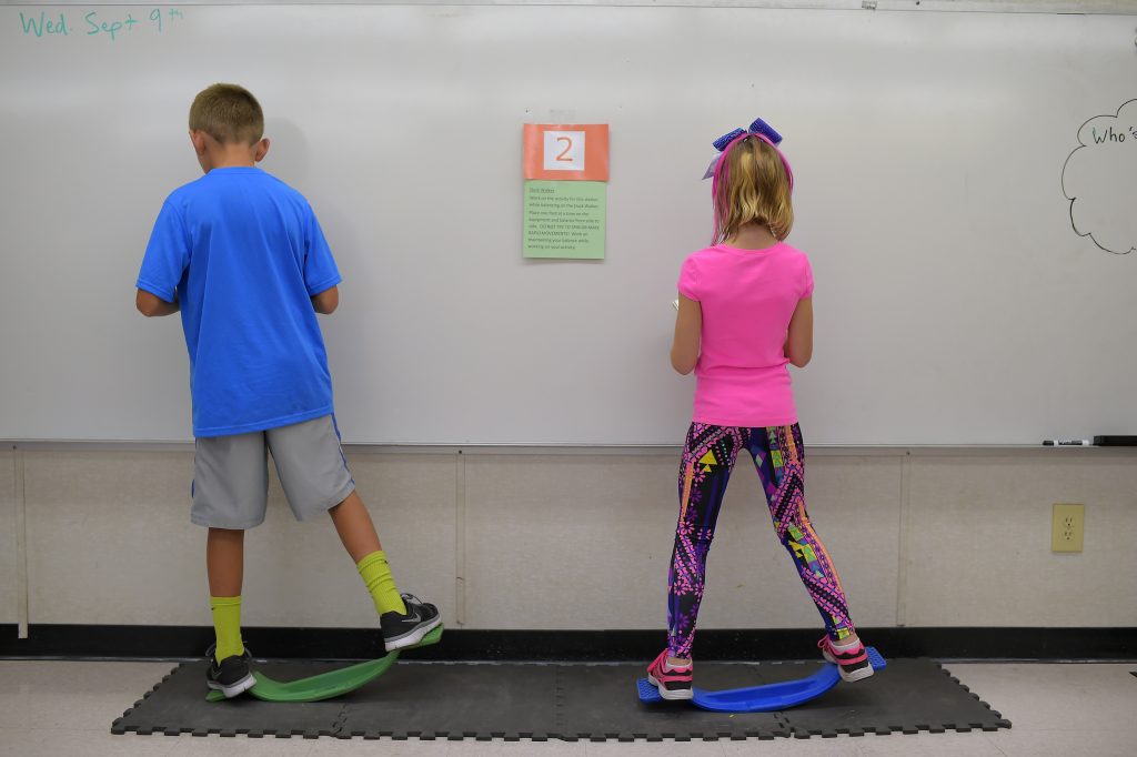 Two fourth-graders rock side to side while doing math equations at Charles Pinckney Elementary School’s “Brain Room” in Charleston, S.C., in 2015. Two fourth-graders rock side to side while doing math equations at Charles Pinckney Elementary School's