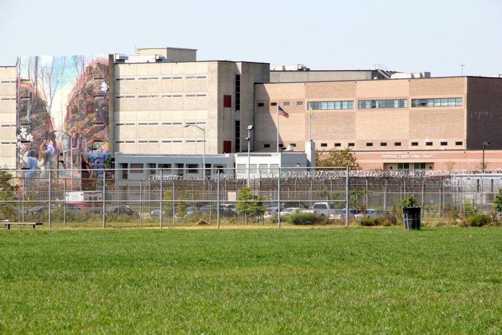 riverside correctional An exterior of a prison is shown, with green grass visible in the foreground.