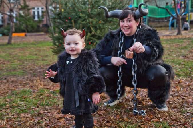 Amy Grant and her daughter Hazel Grant don horns for the annual Parade of Spirits gathering at Liberty Lands Park. (Kimberly Paynter/WHYY)
