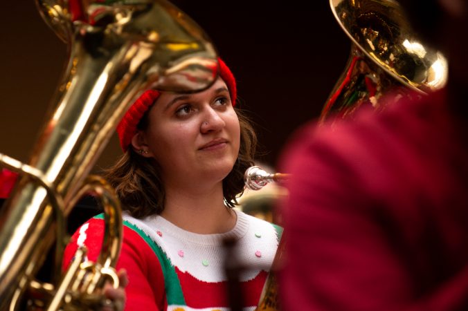 Jenn Michel of Washington Crossing listens during a performance of a Tuba Christmas. (Kriston Jae Bethel for WHYY)