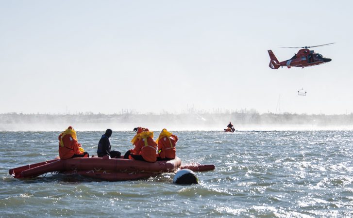 SERE trainees await rescue by the U.S. Coast Guard. (U.S. Air Force photo by Senior Airman Ariel Owings)