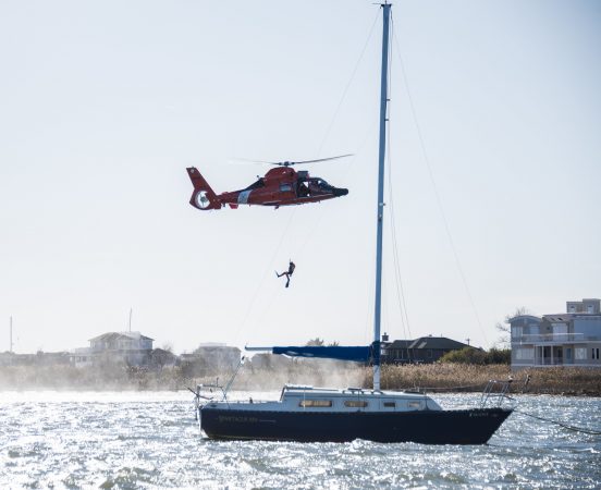 A rescue diver descends from a U.S. Coast Guard helicopter during SERE training. (U.S. Air Force photo by Senior Airman Ariel Owings)