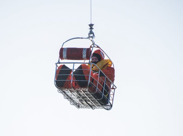 A SERE trainee is hoisted into a U.S. Coast Guard helicopter. (U.S. Air Force photo by Senior Airman Ariel Owings)