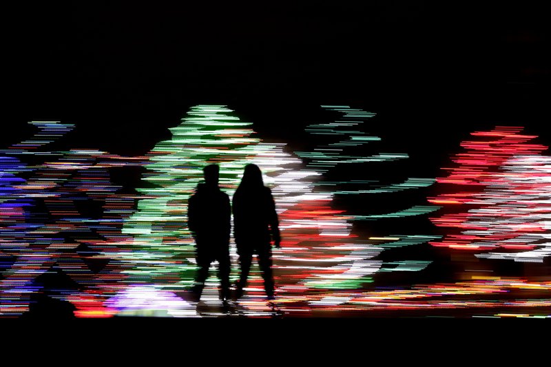 800 People silhouetted against a Christmas display, at a park in Lenexa, Kan. Most Americans say the holiday season makes them feel very grateful and generous — but many report feeling stressed, too according to a new poll from The Associated Press-NORC Center for Public Affairs Research. (Charlie Riedel/AP Photo)