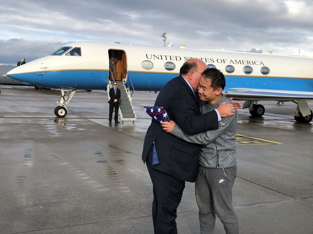 Iran US This photo provided by U.S. Embassy Switzerland, Edward McMullen greets Xiyue Wang in Zurich, Switzerland on Saturday, Dec. 7, 2019. In a trade conducted in Zurich, Iranian officials handed over Chinese-American graduate student Xiyue Wang, detained in Tehran since 2016, for scientist Massoud Soleimani, who had faced a federal trial in Georgia. (U.S. Embassy Switzerland via AP)