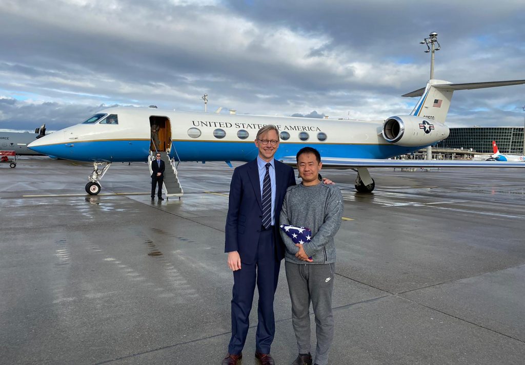 Iran US This photo provided by the U.S. State Department, U.S. special representative for Iran, Brian Hook stands with Xiyue Wang in Zurich, Switzerland on Saturday, Dec. 7, 2019. In a trade conducted in Zurich, Iranian officials handed over Chinese-American graduate student Xiyue Wang, detained in Tehran since 2016, for scientist Massoud Soleimani, who had faced a federal trial in Georgia. (U.S. State Department via AP)