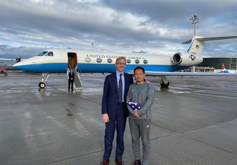 This photo provided by the U.S. State Department, U.S. special representative for Iran, Brian Hook stands with Xiyue Wang in Zurich, Switzerland on Saturday, Dec. 7, 2019.  In a trade conducted in Zurich, Iranian officials handed over Chinese-American graduate student Xiyue Wang, detained in Tehran since 2016, for scientist Massoud Soleimani, who had faced a federal trial in Georgia. (U.S. State Department via AP)