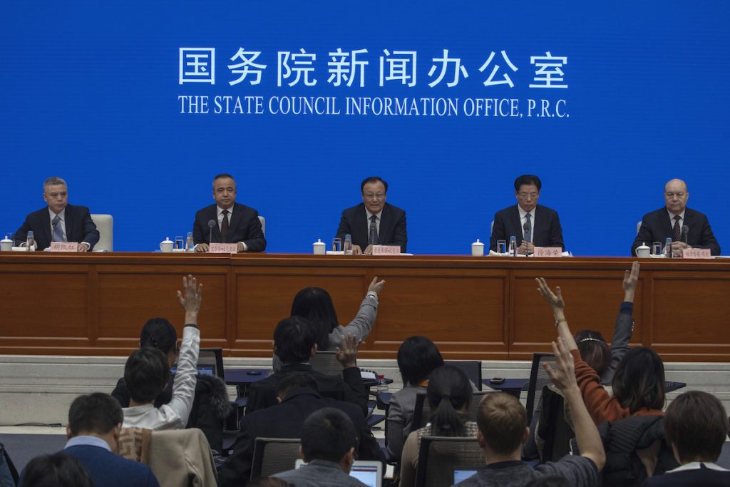 Shohrat Zakir, chairman of China's Xinjiang Uighur Autonomous Region, (center), waits for questions during a press conference in Beijing on Monday, Dec. 9, 2019. (Ng Han Guan/AP Photo)