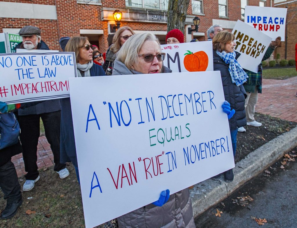 Impeach Trump Rally Rebecca Harlan, Ventnor held her sign up Thursday, Dec. 12, 2019, near the Mays Landing, N.J., office of Congressman Jeff Van Drew because of Van Drew no vote on impeachment. (Craig Matthews/The Press of Atlantic City via AP)