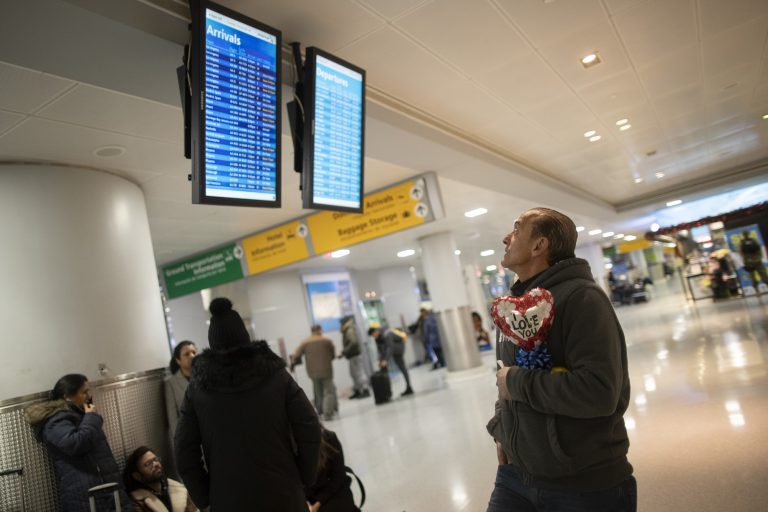 In this Dec. 3, 2019, photo, Mohammed Hafar checks the arrivals road while waiting for his daughter Jana Hafar's flight at JFK Airport in New York. Mohammed Hafar was part of a federal lawsuit filed in August of this year over the travel ban waiver process. “Every time I speak to her, she ask, ‘When are they going to give me the visa?'