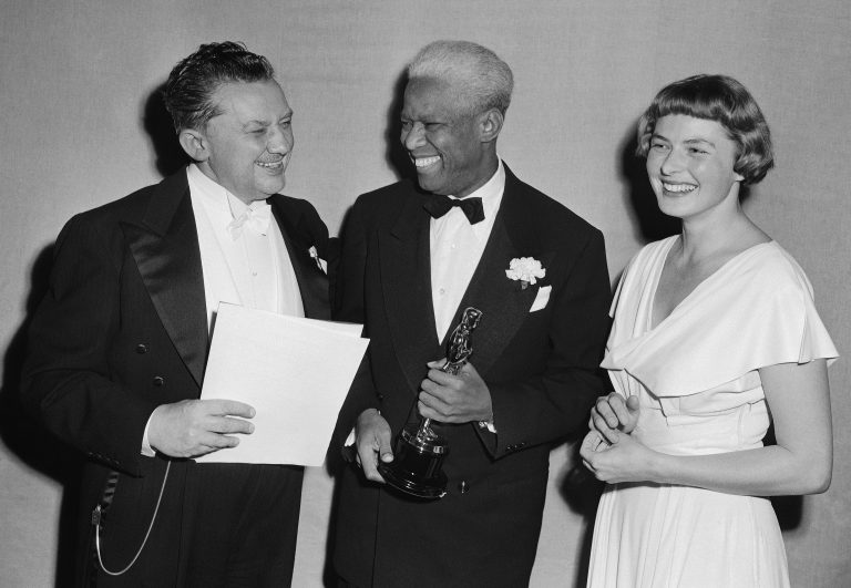 Jean Hersholt, from left, president of Academy of Motion Pictures Arts and Sciences, congratulates James Baskett, second African American to win an Oscar, for his special award for his portrayal of Uncle Remus in the 1946 Disney feature film 