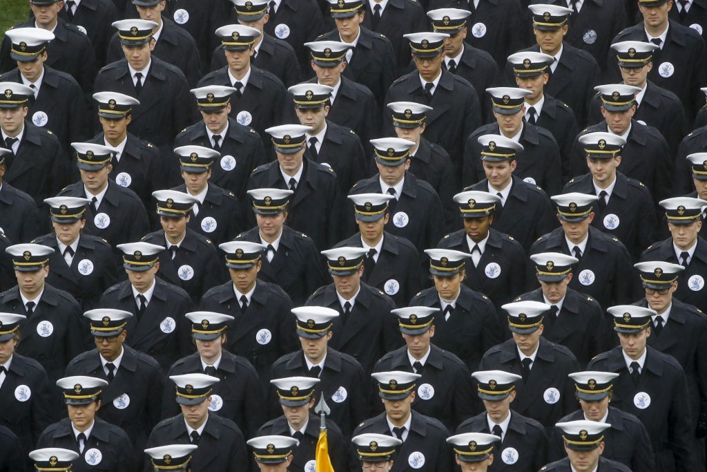 Navy midshipmen march onto field ahead of an NCAA college football game between the Army and the Navy in Philadelphia. (Matt Rourke/AP Photo)
