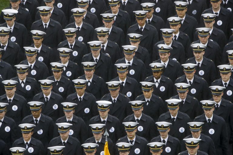 Navy midshipmen march onto field ahead of an NCAA college football game between the Army and the Navy in Philadelphia. (Matt Rourke/AP Photo)