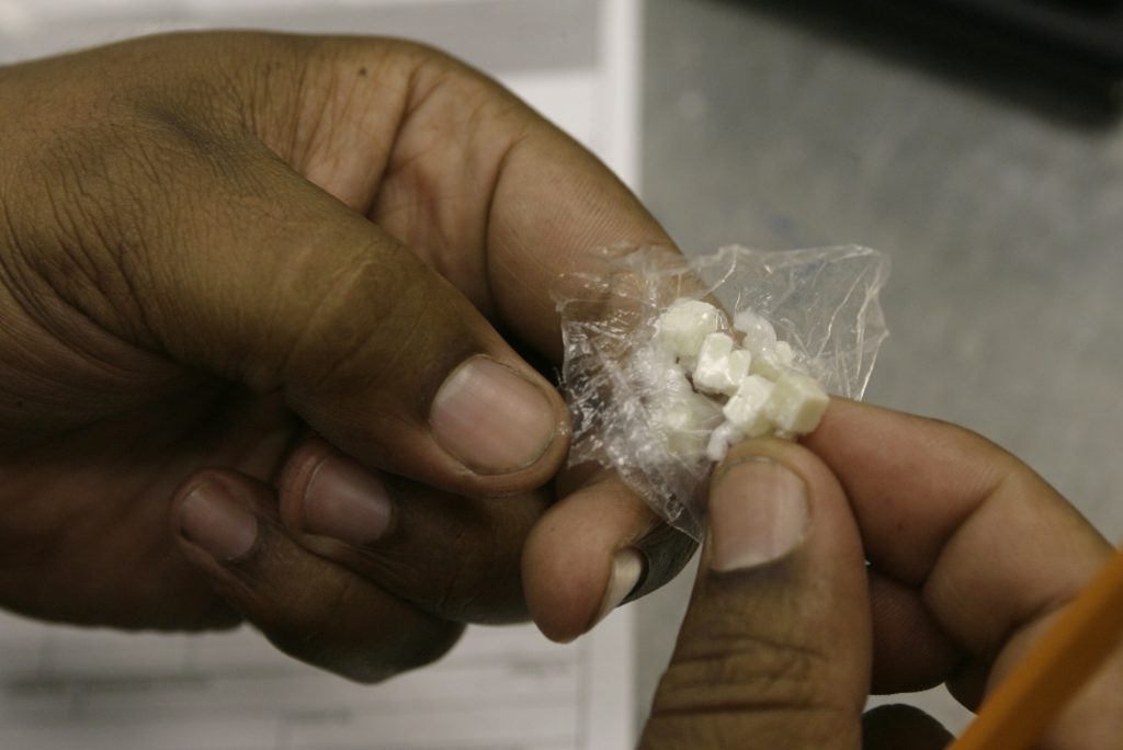 Crack Hopeful Prisoners A Los Angeles Police Officer counts the number of doses of Crack cocaine, as he files an evidence police report Tuesday, Oct. 10, 2006. (AP Photo/Damian Dovarganes)