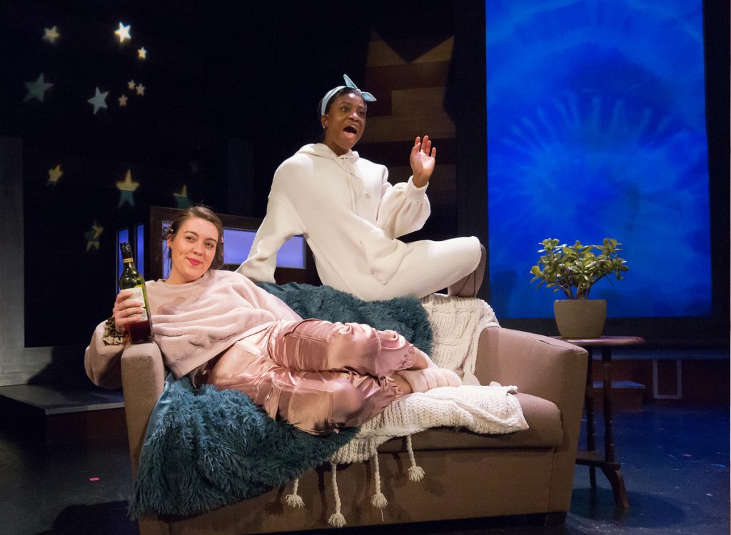 Tanaquil Márquez (left) and Brett Ashley Robinson in a skit about self-care at 'This Is the Week That Is.' (Courtesy of Mark Garvin) 