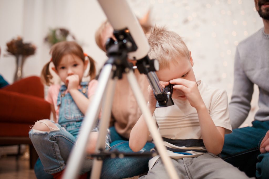 Picture of happy family with telescope child with telescope