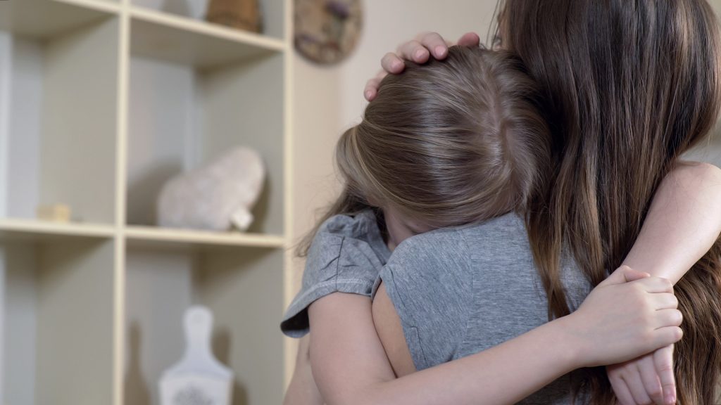 Woman Comforting Her Upset Or Sick Child Carefully, Mother Huggi Kids know their abusers between 85% and 93% of the time. Yet that often comes as a surprise to adults.(motortion/BigStock)