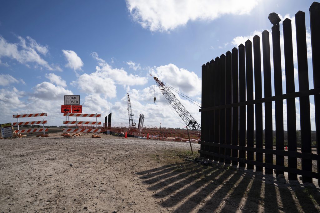 The existing border wall (right) is seen near the construction site of new wall panels south of Donna, Texas, on Nov. 20. There is widespread skepticism on the border that President Trump will get anywhere near the 450 miles of wall he wants by next November. The existing border wall (right) is seen near the construction site of new wall panels south of Donna, Texas. (Verónica G. Cárdenas for NPR)