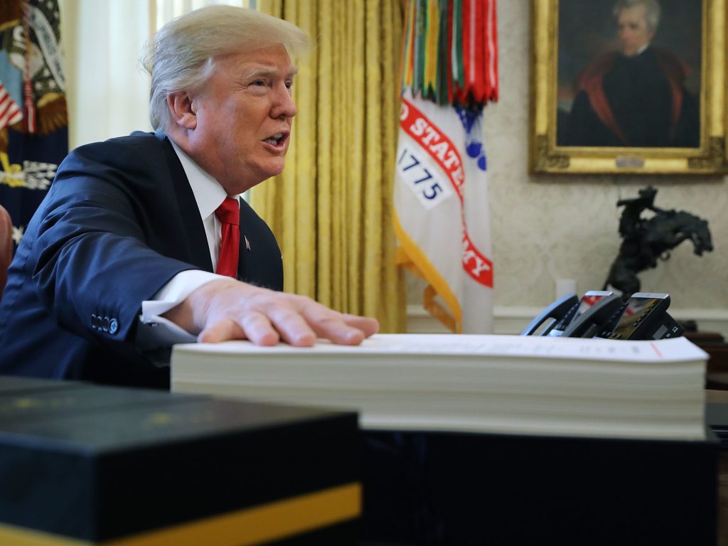 President Trump prepares to sign the tax legislation in the Oval Office on Dec. 22, 2017. The GOP tax cut did not pay for itself, as promised, nor did it deliver a sustained boost to economic growth. President Trump prepares to sign the tax legislation in the Oval Office on Dec. 22, 2017. The GOP tax cut did not pay for itself, as promised, nor did it deliver a sustained boost to economic growth. (Chip Somodevilla/Getty Images)