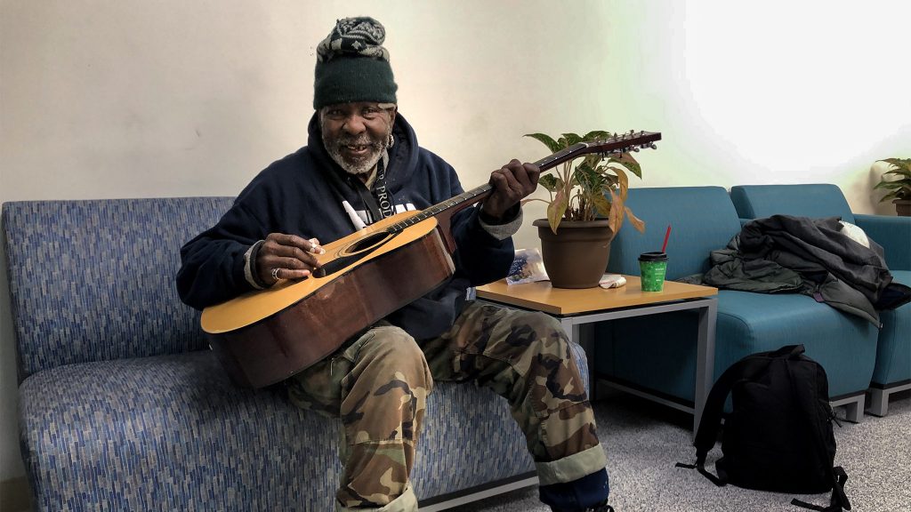 hubofhope-music-02crop John Oliver, Jr., plays guitar at Hub of Hope's Living Room (Michaela WInberg/Billy Penn)
