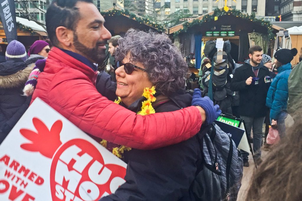 hug mobster Edie Weinstein gives out hugs at the Christmas Village in Center City. (Annette John-Hall/WHYY)