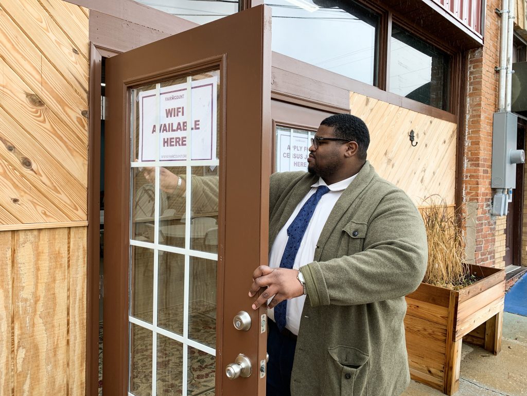 Anthony Hill, Fair Count’s communications associate, posts signs encouraging people to use the free Wi-Fi and apply for 2020 census jobs at ARC Community Center in Fort Gaines, Ga. Anthony Hill, Fair Count's communications associate, posts signs encouraging people to use the free Wi-Fi and apply for 2020 census jobs at ARC Community Center in Fort Gaines, Ga. (Hansi Lo Wang/NPR)