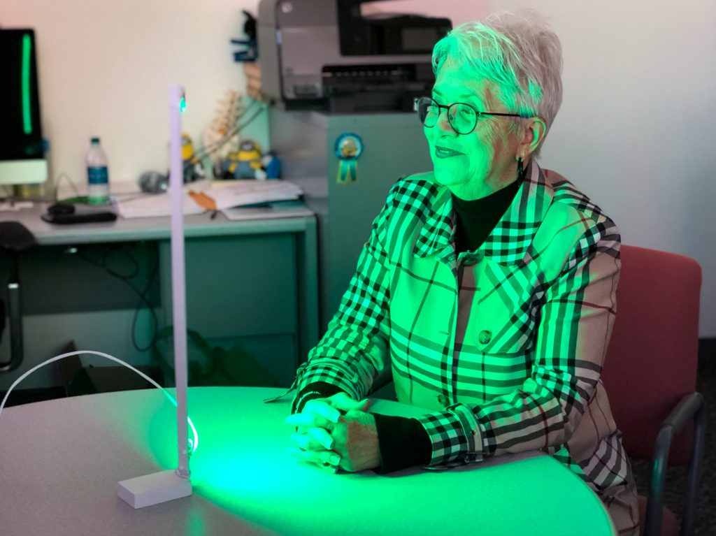 Ann Jones has been spending two hours each day in front of a green LED light — an experimental treatment aimed at alleviating migraines and other forms of chronic pain. Ann Jones has been spending two hours each day in front of a green LED light — an experimental treatment aimed at alleviating migraines and other forms of chronic pain. (Will Stone for NPR)