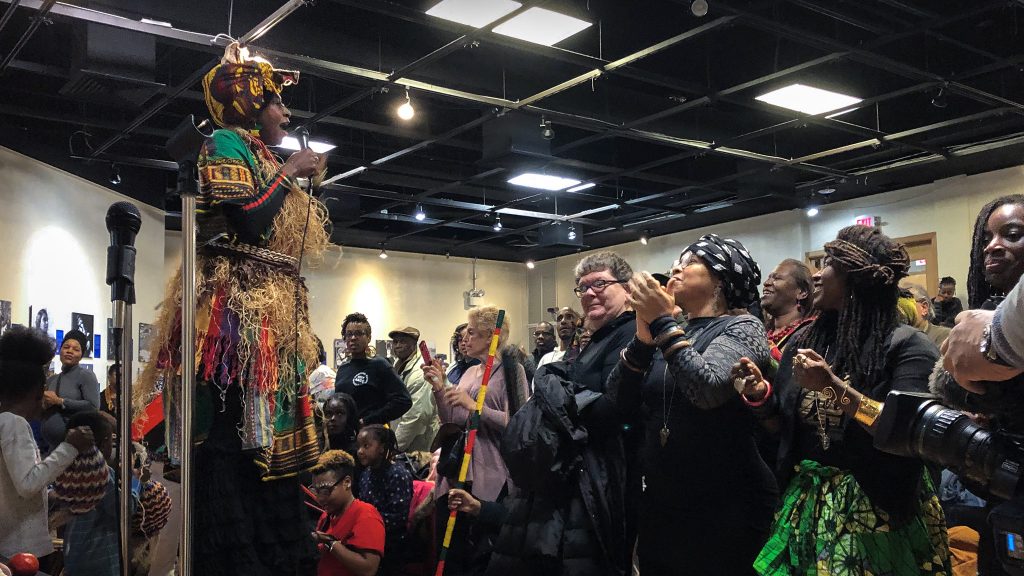kwanzaa201-michaelawinberg-01crop A stilt-walker leads the crowd celebrating Kwanzaa in the auditorium of the African American Museum in Philadelphia. (Michaela Winberg/Billy Penn)